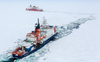 Two ships in icy waters.